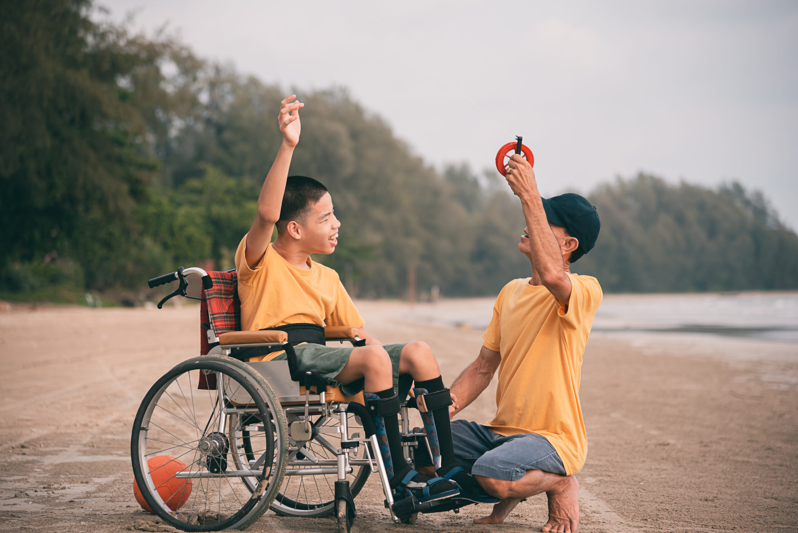 Child in wheelchair learning outdoors with support – NDIS Skills Development and Training for practical independence FAQ