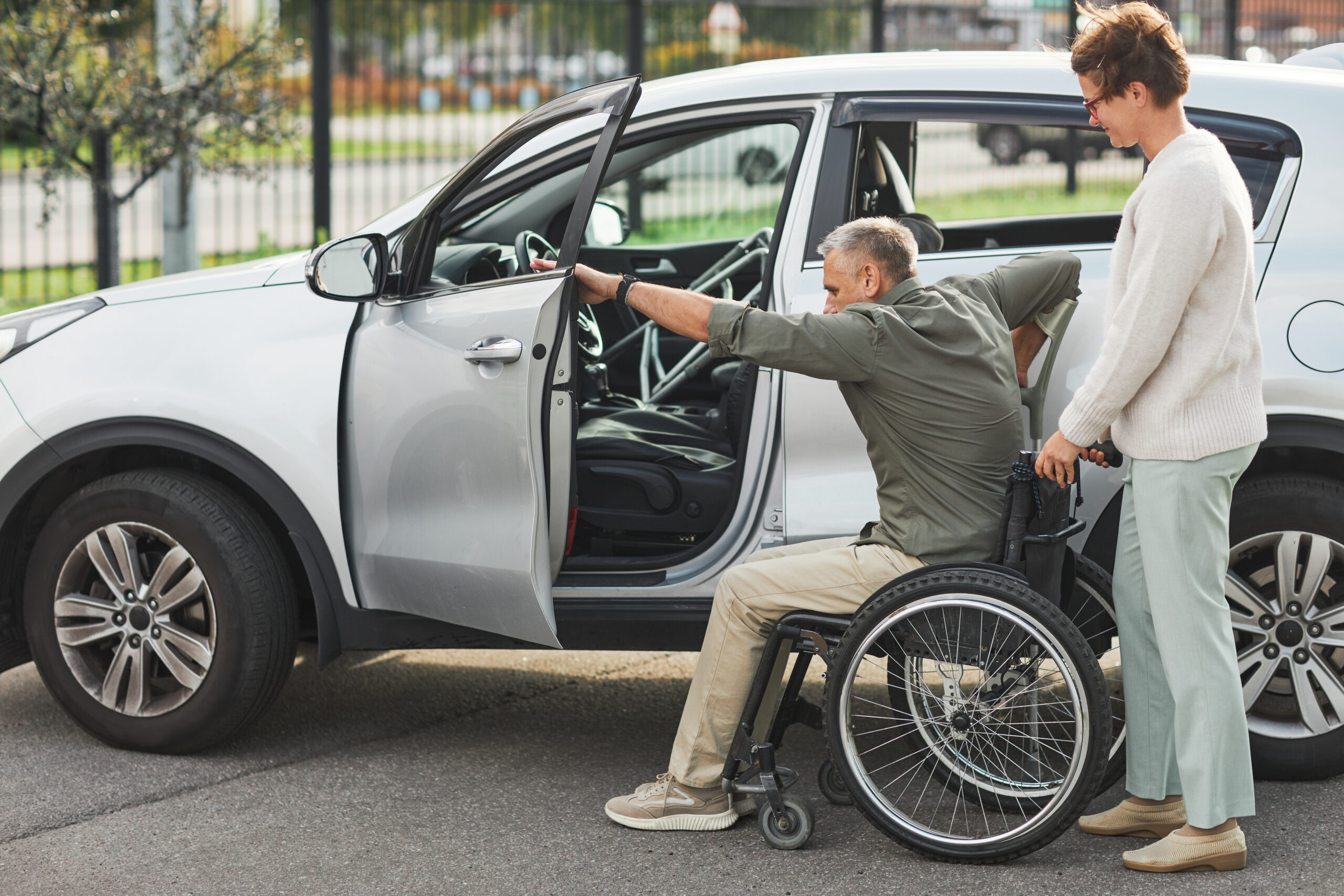 NDIS participant in wheelchair being supported into a transport vehicle in Darwin