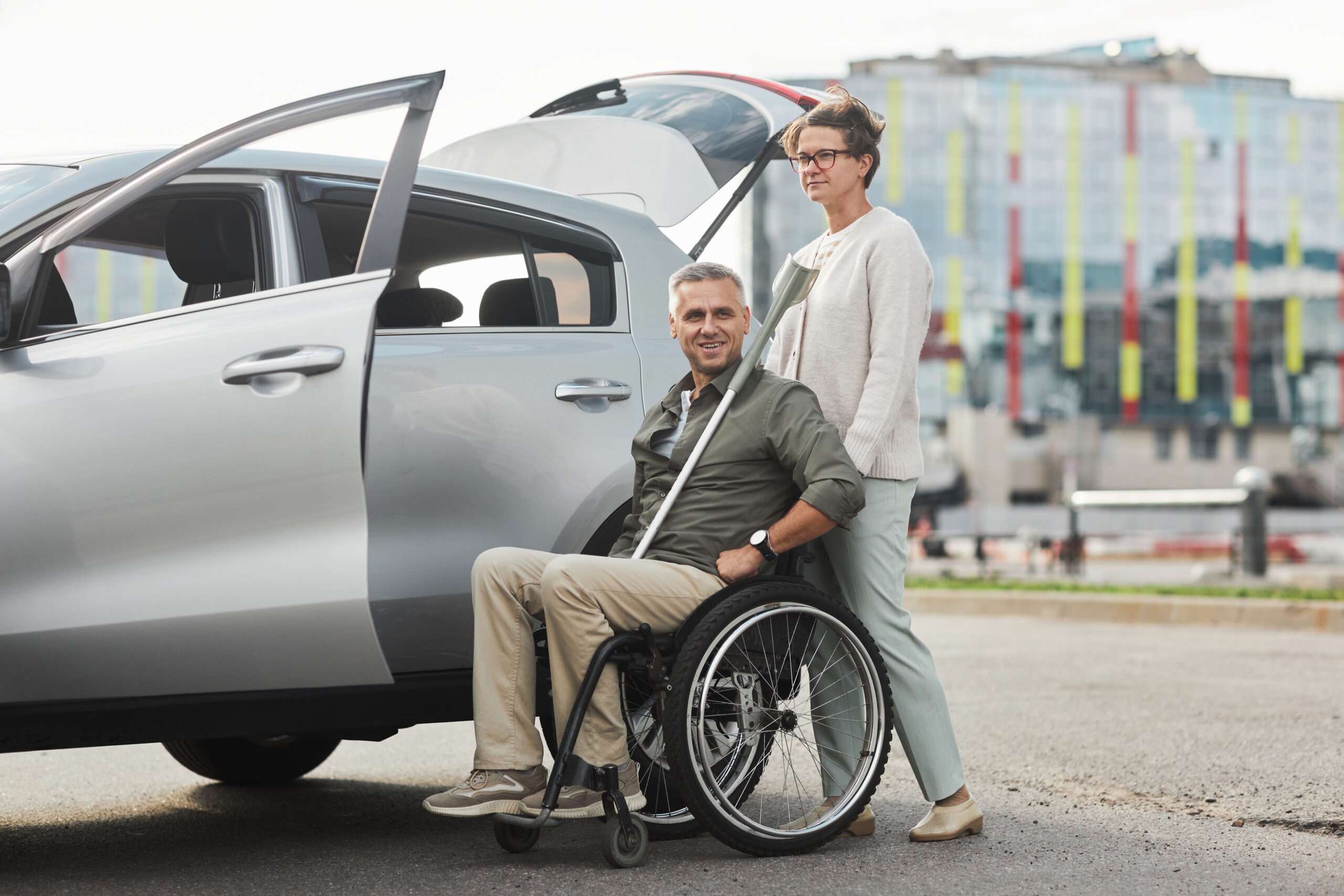 NDIS participant in wheelchair being supported into a transport vehicle in Darwin
