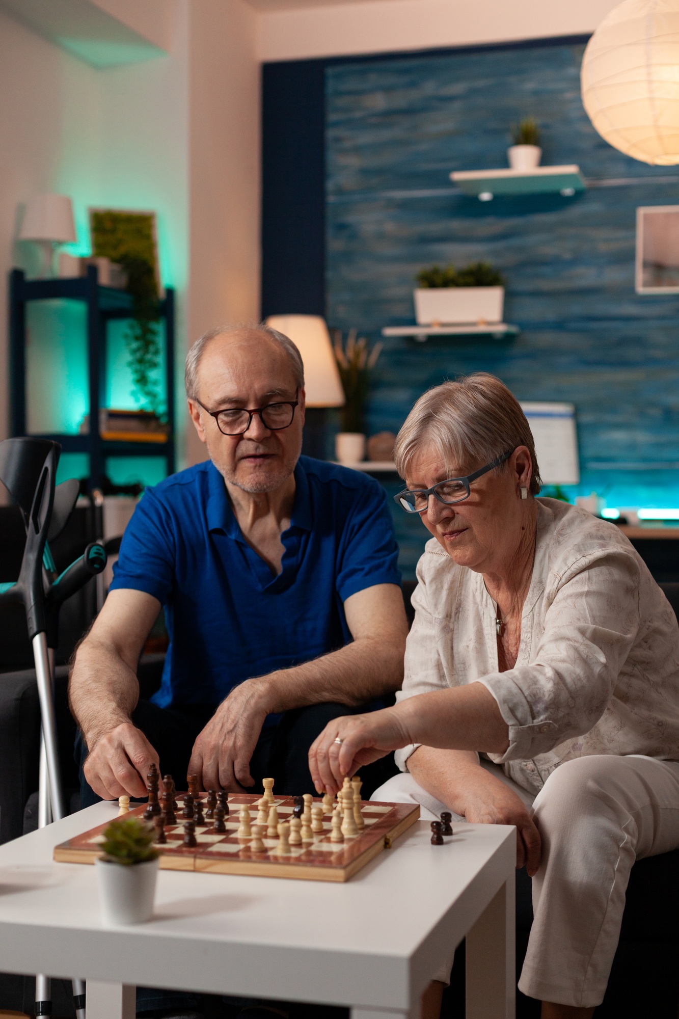 Seniors playing chess in NDIS STA setting – safe, personalised NDIS STA and respite support including meals, care & activities