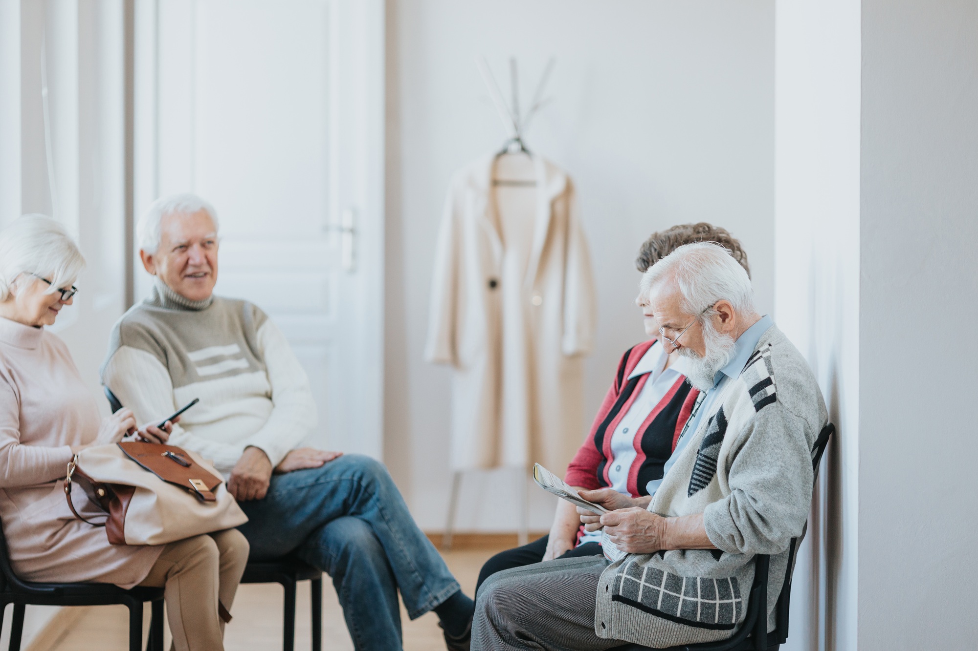 Elderly individuals in group setting – discussing NDIS Short-Term Accommodation eligibility and respite funding options
