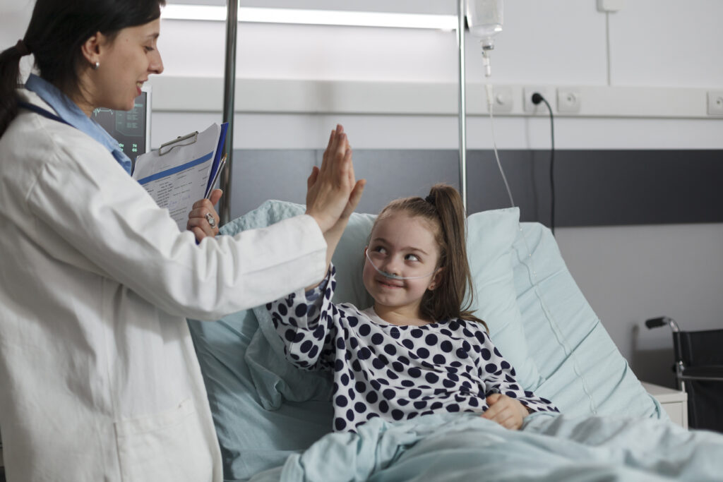 Smiling child high-fiving nurse – Getting started with Complex Wound Care Nursing Process at Connectors Wellbeing